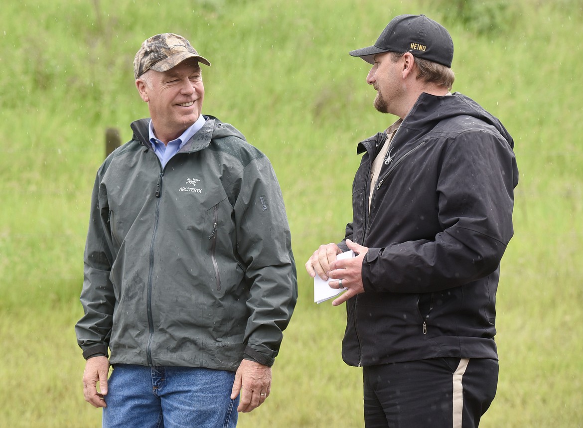 Flathead County Sheriff Brian Heino updates Gov. Greg Gianforte on flooding in Northwest Montana during a briefing Monday, June 20 at the Old Steel Bridge fishing access on the Flathead River in Evergreen. (Matt Baldwin/Daily Inter Lake)