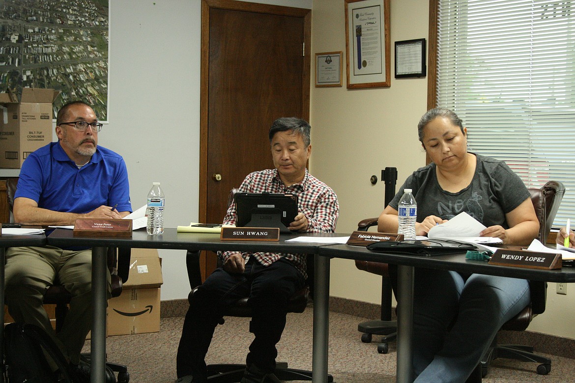 Mattawa City Council members (from left) Brian Berghout, Sun Hwang and Fabiola Hernandez listen to a presentation during the June 16 council meeting.