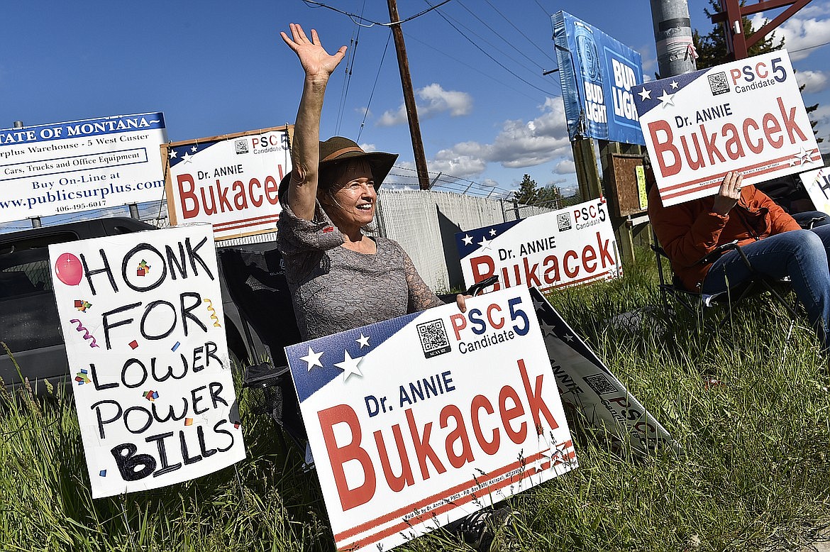 Dr. Annie Bukacek, a candidate for Public Service Commission district 5, waves to motorists outside the Lewis and Clark County Fairgrounds during the state's primary election in Helena, Mont., on Tuesday, June 7, 2022. (Thom Bridge/Independent Record via AP)