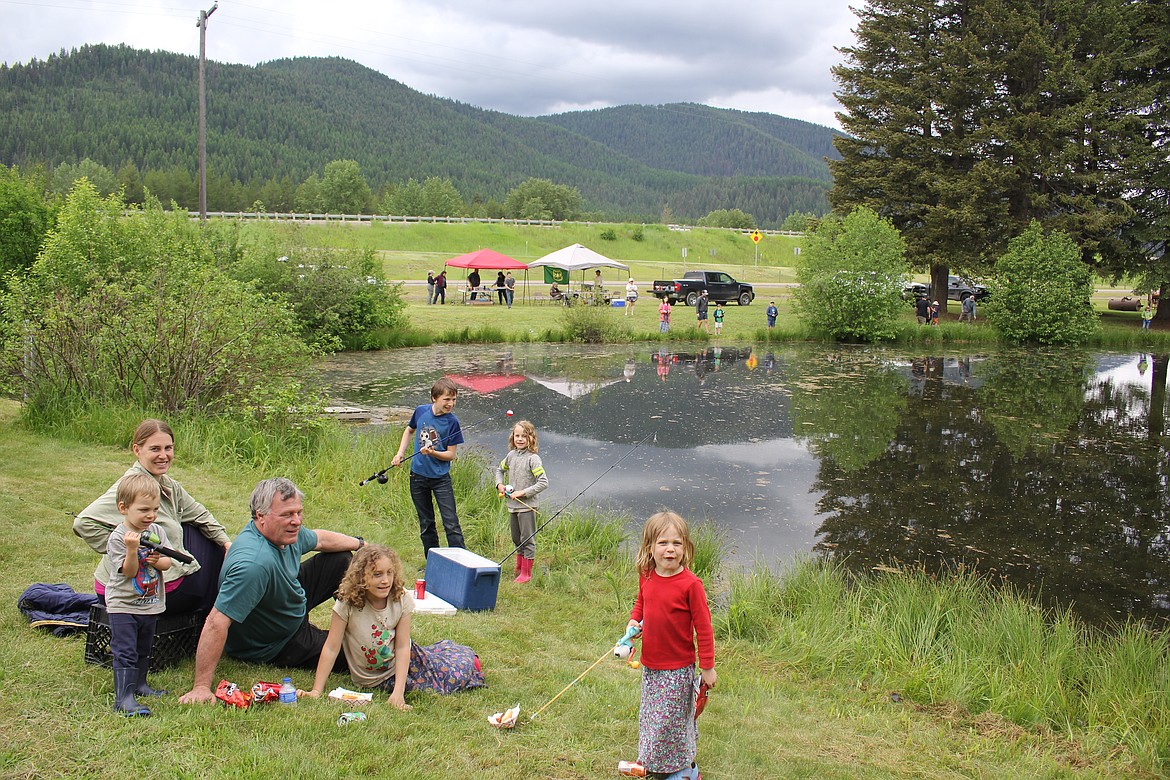 Families enjoy fishing at the Savenac Kids Fishing day on Saturday. The weather was sprinkly and the fishing could have been better, but the sponsors, Lolo National Forest, Montana FWP and Friends of Savenac couldn’t have been more accommodating. (Monte Turner/Mineral Independent)