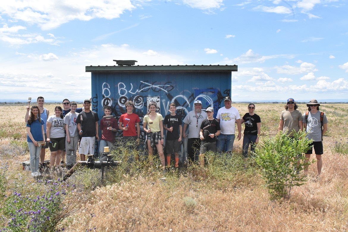 Light of Larson and Citipoint Church members smile just before tackling their next graffiti coverup project in Moses Lake on Saturday.