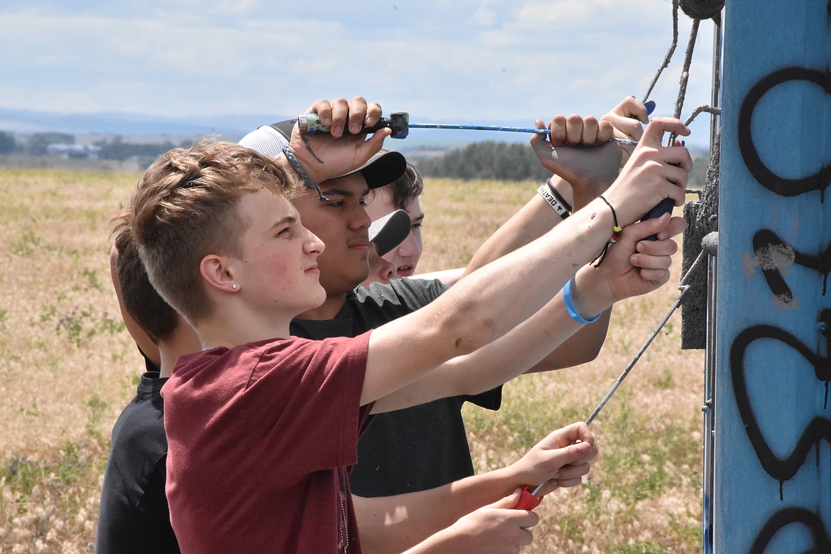 With just paintbrushes, about a dozen youth took back Moses Lake by covering up graffiti.