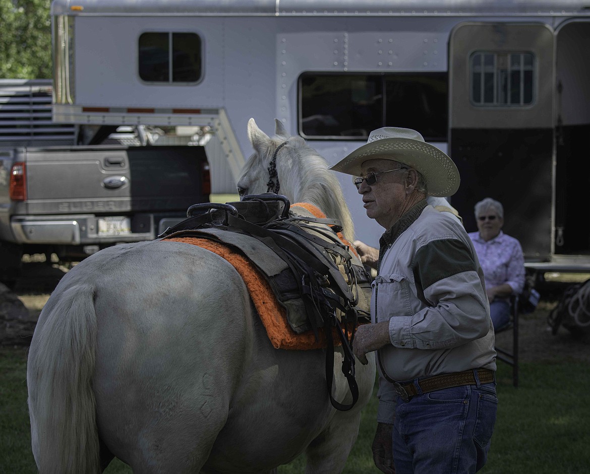David Crawford teaches participants how to saddle a mule. (Tracy Scott/Valley Press)