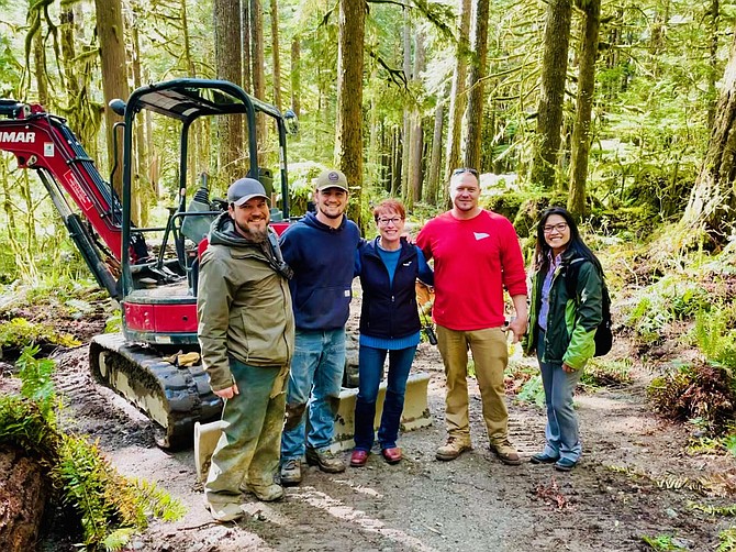 Verdis President Sandy Young, center, is joined by Superintendent Gordon Coles, Laborer Kaiden Hoskins, Superintendent Robbie Dietrich and Project Manager Vy Buck during a site visit at North Cascades National Park in May 2022. Verdis was hired to repair and replace a water line from the reservoir to Marblemount Ranger Station.