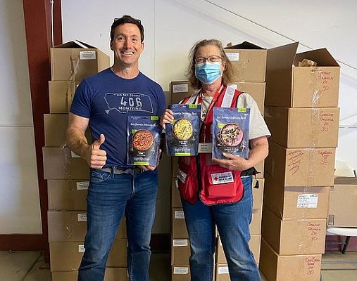 David Diehl, left, poses with a Red Cross aid worker in Red Lodge following the devastating Yellowstone flooding last week. Diehl, head of gear operations at Columbia Falls-based RightOnTrek, delivered packaged meals to aid in the relief effort. (Photo courtesy RightOnTrek)