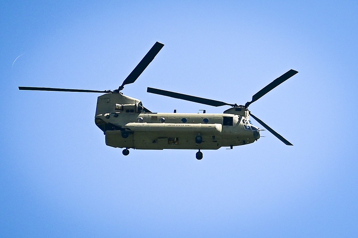 A U.S. Army Chinook flies over flooding along the Flathead River on Tuesday, June 21. (Casey Kreider/Daily Inter Lake)