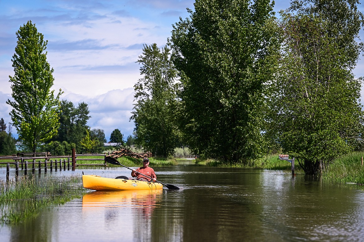 Robert Miller paddles out from his property on Wagner Lane to survey flooding from the Flathead River on Tuesday, June 21. Miller measured 28 inches of standing water in some places near his property. He and five other residences at the end of Wagner Lane have chosen to stay through a pre-evacuation notice issued by the Flathead County Sheriff's Office.(Casey Kreider/Daily Inter Lake)