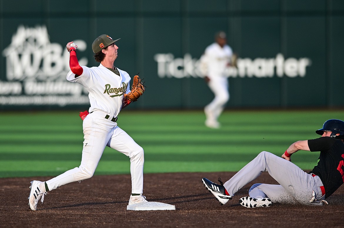 Glacier Range Riders second baseman Ryan Cash (5) throws to first to complete an inning-ending double play in the sixth against the Great Falls Voyagers at Flathead Field on Tuesday, June 21. (Casey Kreider/Daily Inter Lake)