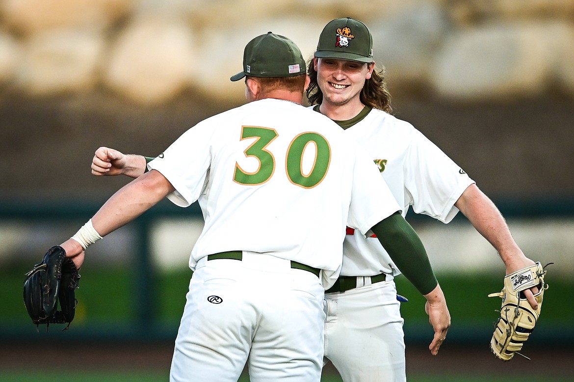 Glacier Range Riders third baseman Dean Miller (30) and first baseman Brody Wofford (24) celebrate after a 2-0 win over the Great Falls Voyagers at Flathead Field on Tuesday, June 21. (Casey Kreider/Daily Inter Lake)