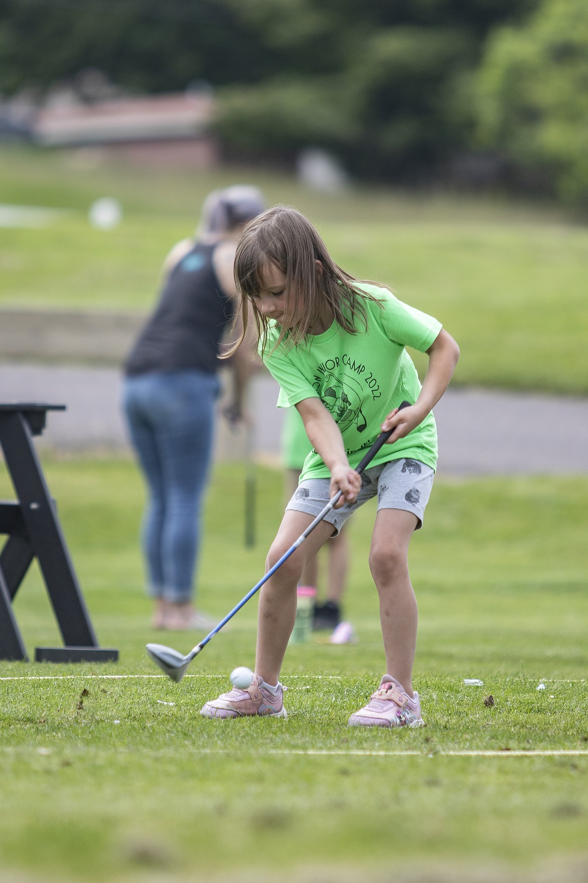 Pearl Bagley makes contact with the ball during the Junior Camp Pitch, Putt, and Drive Competition held at the Polson Bay Golf Course on Friday.
