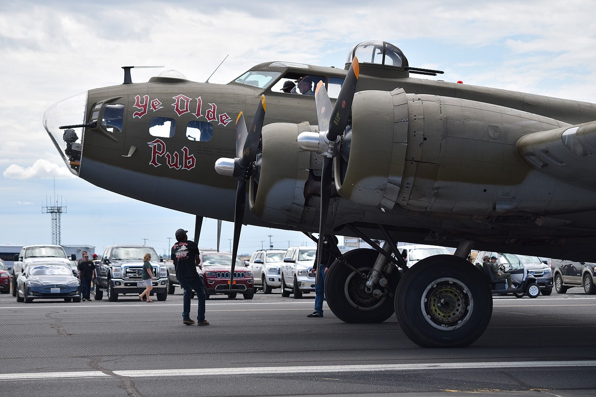A ground crew member stabilizes the propellers of the Erikson Aircraft Collection’s B-17 Flying Fortress following a short flight during the Moses Lake Airshow on Saturday. Erikson offered rides in the plane to paying passengers.