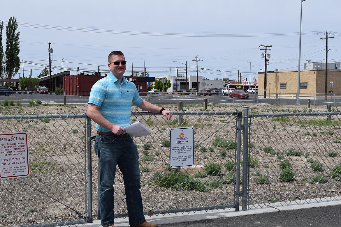 Levi Bisnett stands in front of a gate to a lot the city of Moses Lake will use to establish a food truck park. Bisnett and his coworkers are looking for ways to improve quality of life for residents of Moses Lake and the surrounding area that will also draw in tourism dollars to shore up the city’s economy.