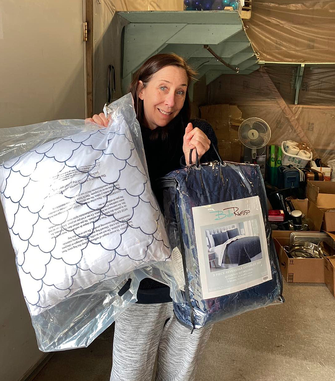 Safety Net InlandNW executive director Molly Allen shows off a few items during a donation drive in April. Safety Net and other local nonprofits will be gifted a portion of $85,000 in Women's Gift Alliance grants during an awards presentation Thursday.
