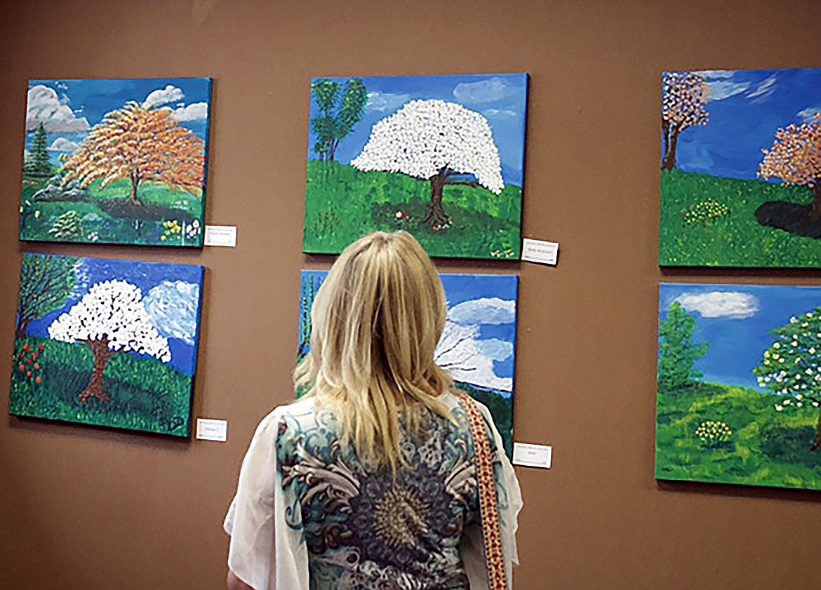 Local seniors took part in their first art exhibition Friday, cutting the ribbon with bright smiles, and talking to guests about their art throughout the evening during opening ArtWalk receptions.