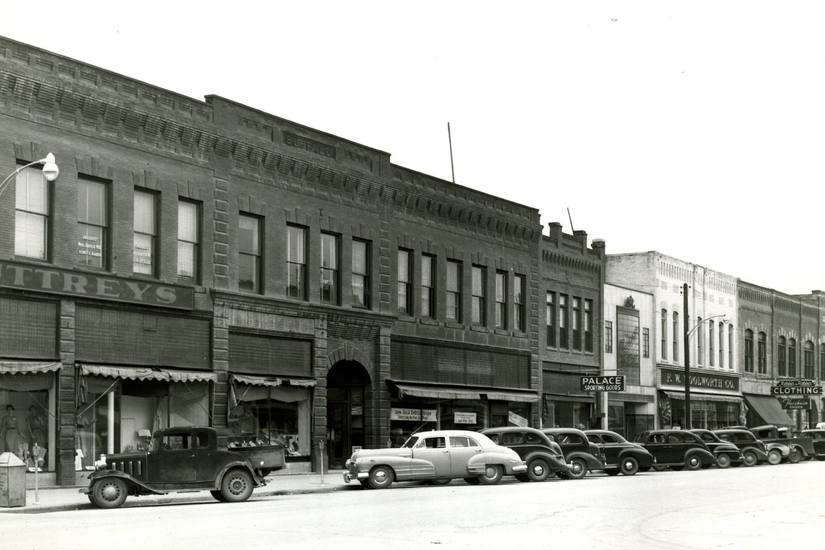 A photo shows the 200 block of Main Street on the west side in 1951. Left to right, Buttery Department Store, The Palace Sporting Goods, Anderson Style Shop, F.W. Woolsorth Co. and Robbin and Robbin Men's Furnishings. (Photo courtesy of Northwest Montana History Museum)