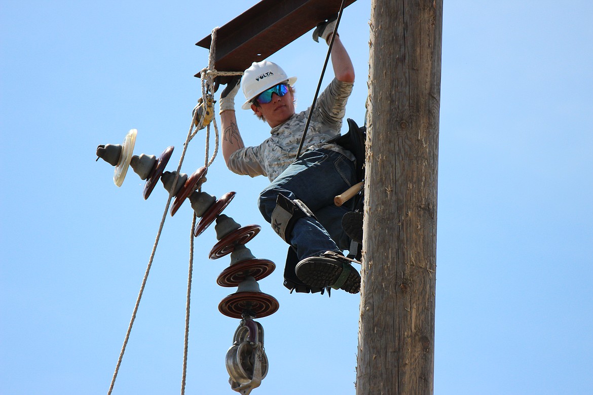 Devin Hoover, from Astoria, Ore., practices replacing insulators on a 115KV simulated power line during lineworker class outside the NIC Parker Technical Education Center recently.
