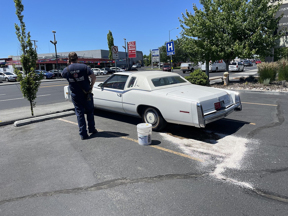 A Moses Lake firefighter responds on Thursday to a leaking gasoline tank in the parking lot of Safeway on South Pioneer Way. While fuel spills are the most common type of incident the MLFD responds to involving hazardous materials, the city has received a nearly $250,000 grant to create a hazardous material team with fire departments in Chelan and Douglas counties to handle bigger incidents.