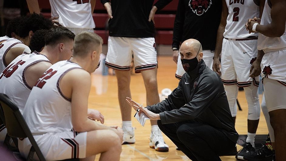 Central Washington head coach Brandon Rinta talks with his team during a Wildcat game. The team is hosting a basketball camp for high school teams this weekend.