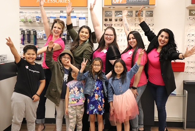 Vision Center and Moses Lake School District staff present migrant students showing off their new glasses.