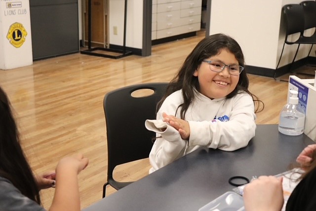 Seeing better makes a difference – a Moses Lake School District student reacts to her new glasses.