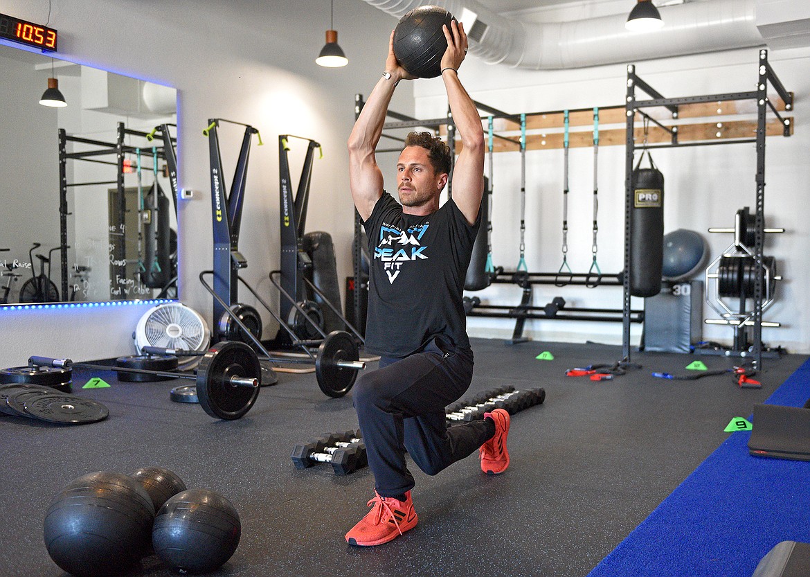 PEAK Fit head trainer Andre Bolourchi demonstrates a functional training exercise in the Whitefish gym on Thursday. (Whitney England/Whitefish Pilot)