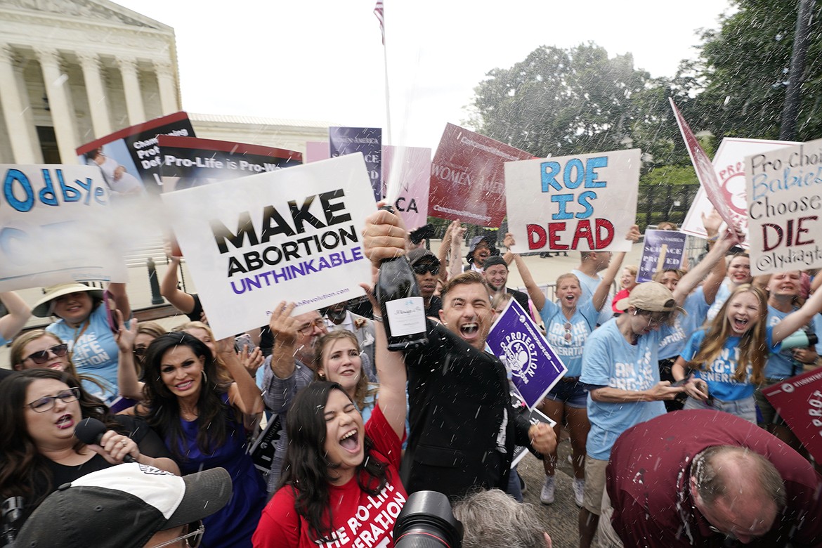 A celebration outside the Supreme Court, Friday, June 24, 2022, in Washington. The Supreme Court has ended constitutional protections for abortion that had been in place nearly 50 years — a decision by its conservative majority to overturn the court's landmark abortion cases.