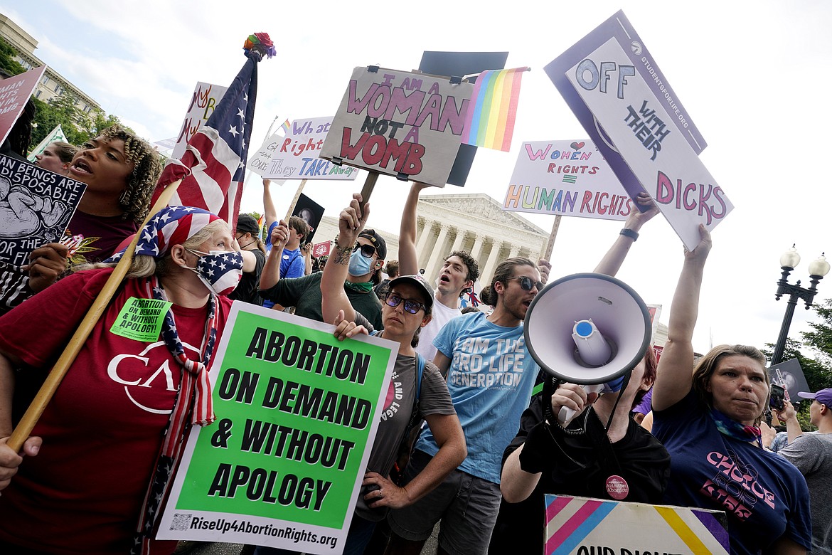 People protest about abortion, Friday, June 24, 2022, outside the Supreme Court in Washington. The Supreme Court has ended constitutional protections for abortion that had been in place nearly 50 years — a decision by its conservative majority to overturn the court's landmark abortion cases.