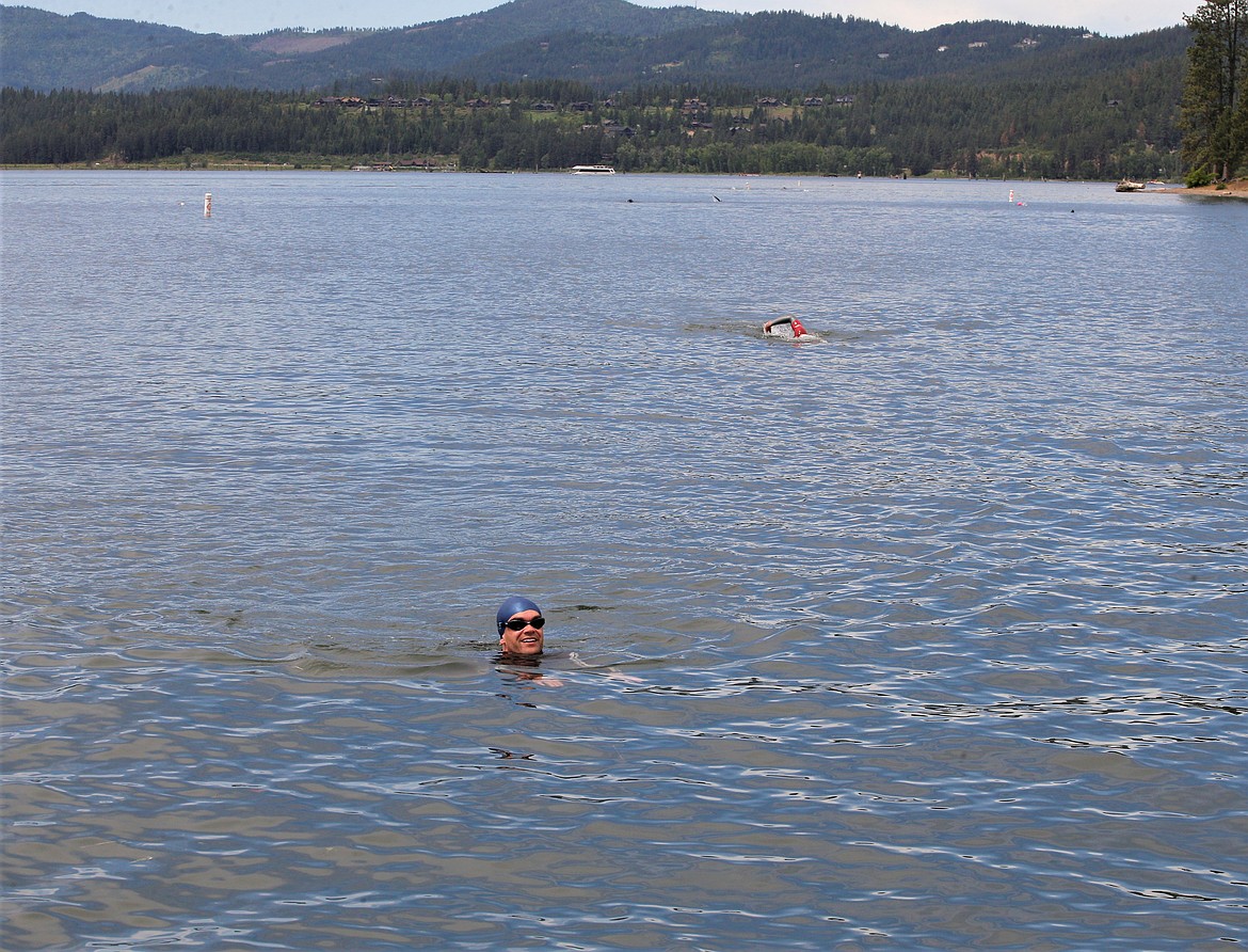 Brett Heron of Calgary, Alberta, Canada, floats his way toward Independence Point after a swim in Lake Coeur d'Alene on Friday.