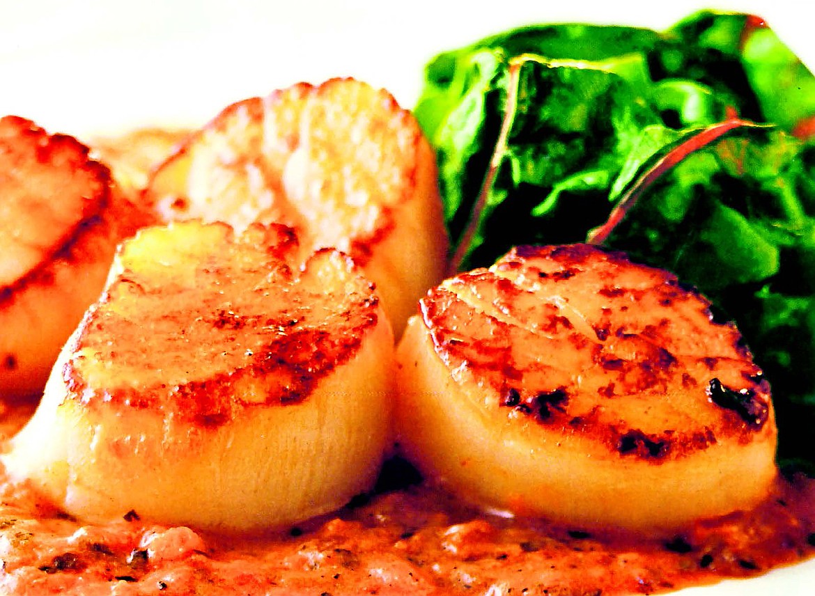 Seared scallops in tarragon with red bell pepper cream sauce make for a delightful dinner.