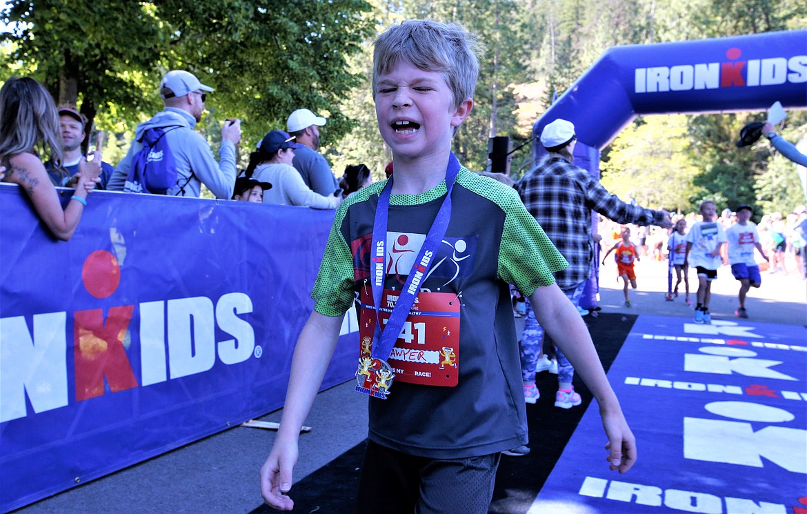 Sawyer Glenn of Coeur d'Alene grimaces after finishing second in a half-mile run during an IronKids race on Saturday at McEuen Park.