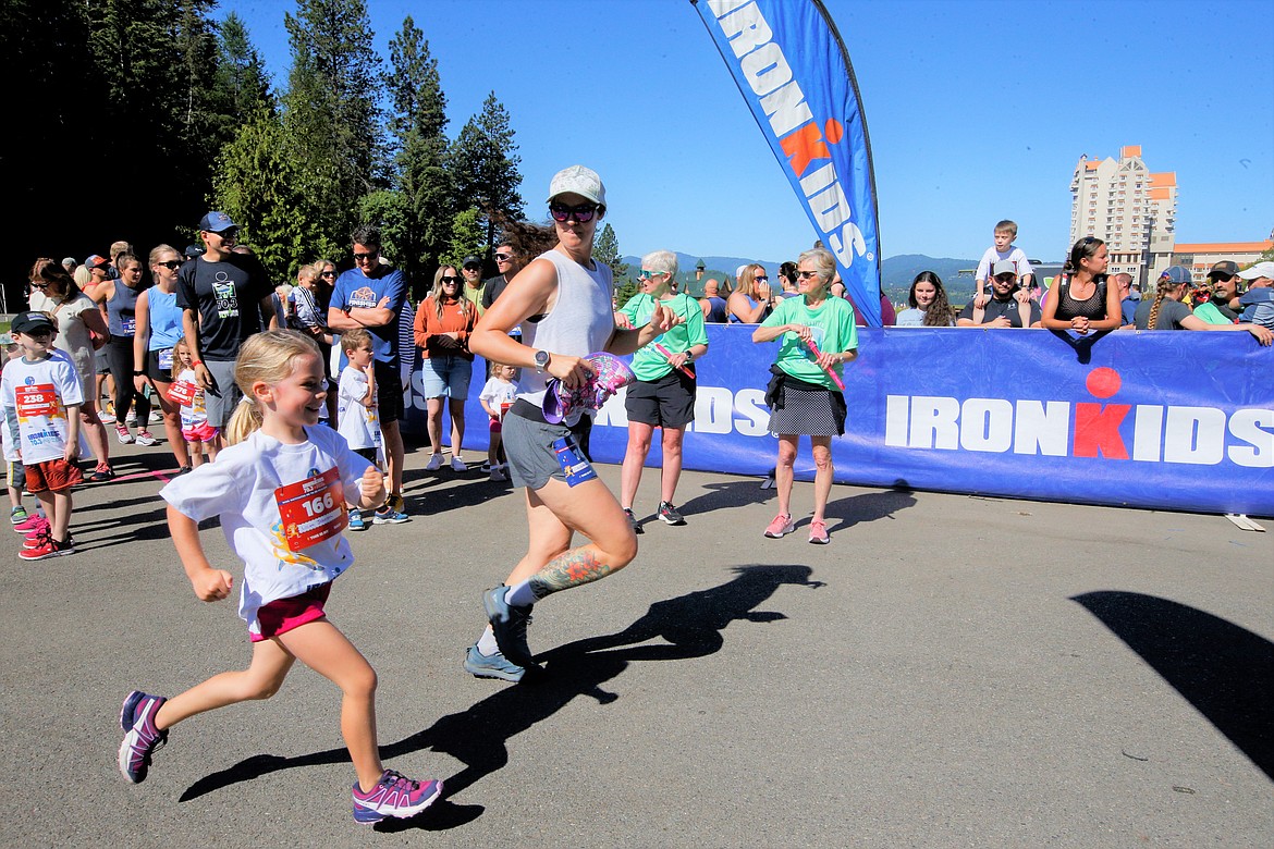 Whitney Johnson and daughter Lillian, 6, run together in IronKids on Saturday.