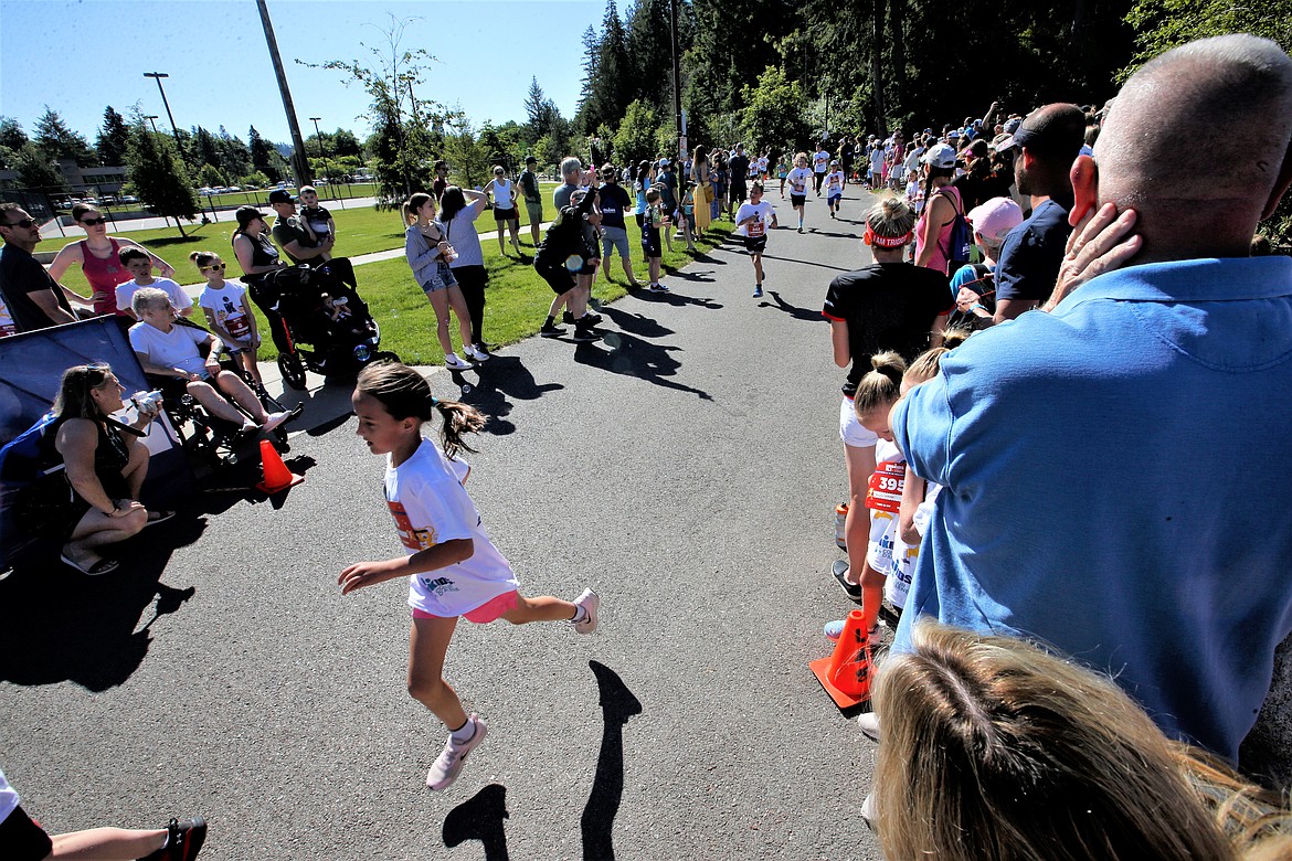 Youth sprint to the finish line of IronKids on Saturday at McEuen Park.