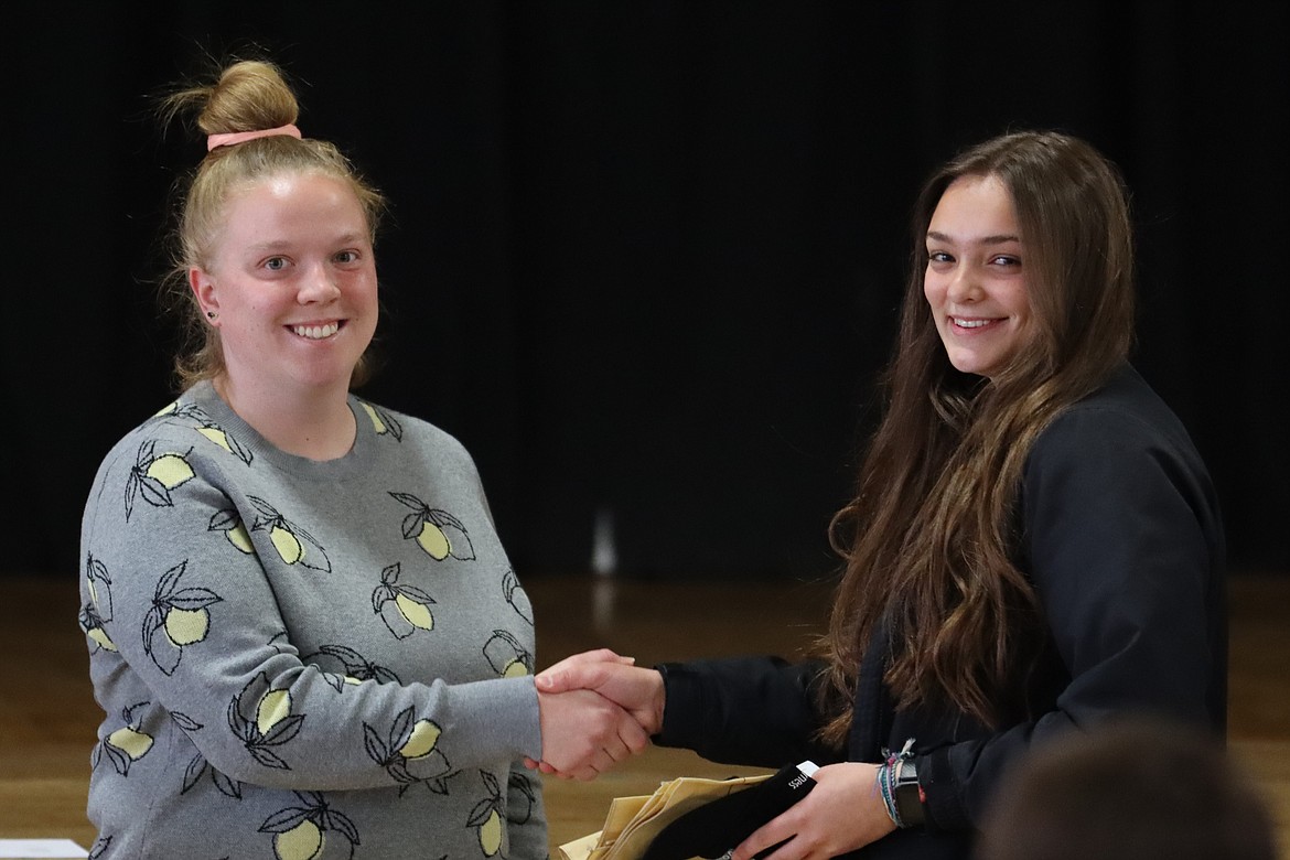 Friends of the Scotchman Peaks Wilderness Northwest Montana Outreach Coordinator Brooke Bolin and Hanna Benson, a Troy High School graduate, shake hands at a recent awards ceremony. (Photo courtesy Friends of the Scotchman Peaks Wilderness)