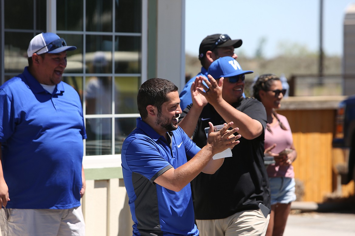 Warden wrestling coaches applaud for those who participated in the tournament.