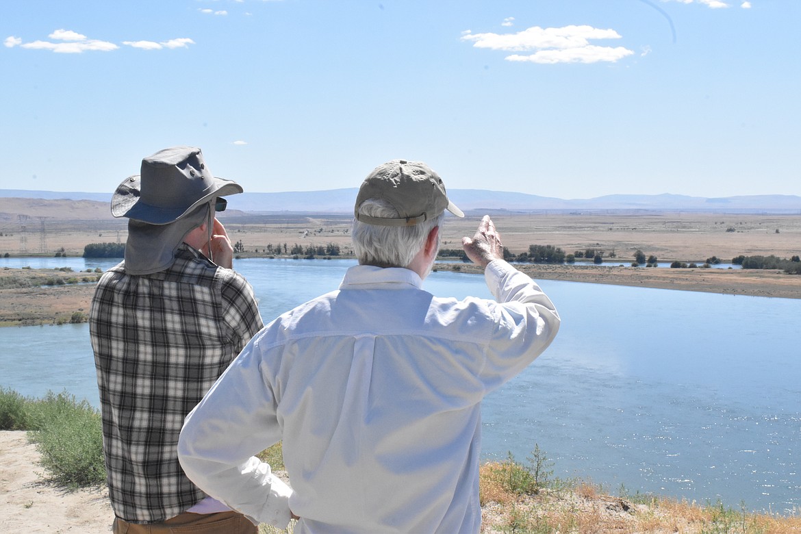 Dan Serres, Conservation Director at Columbia Riverkeeper, left, discusses the different reactors on the Hanford site that can be seen at the Hanford Reach National Monument area with Washington State District 46 Representative Gerry Pollet (D-Seattle), right.