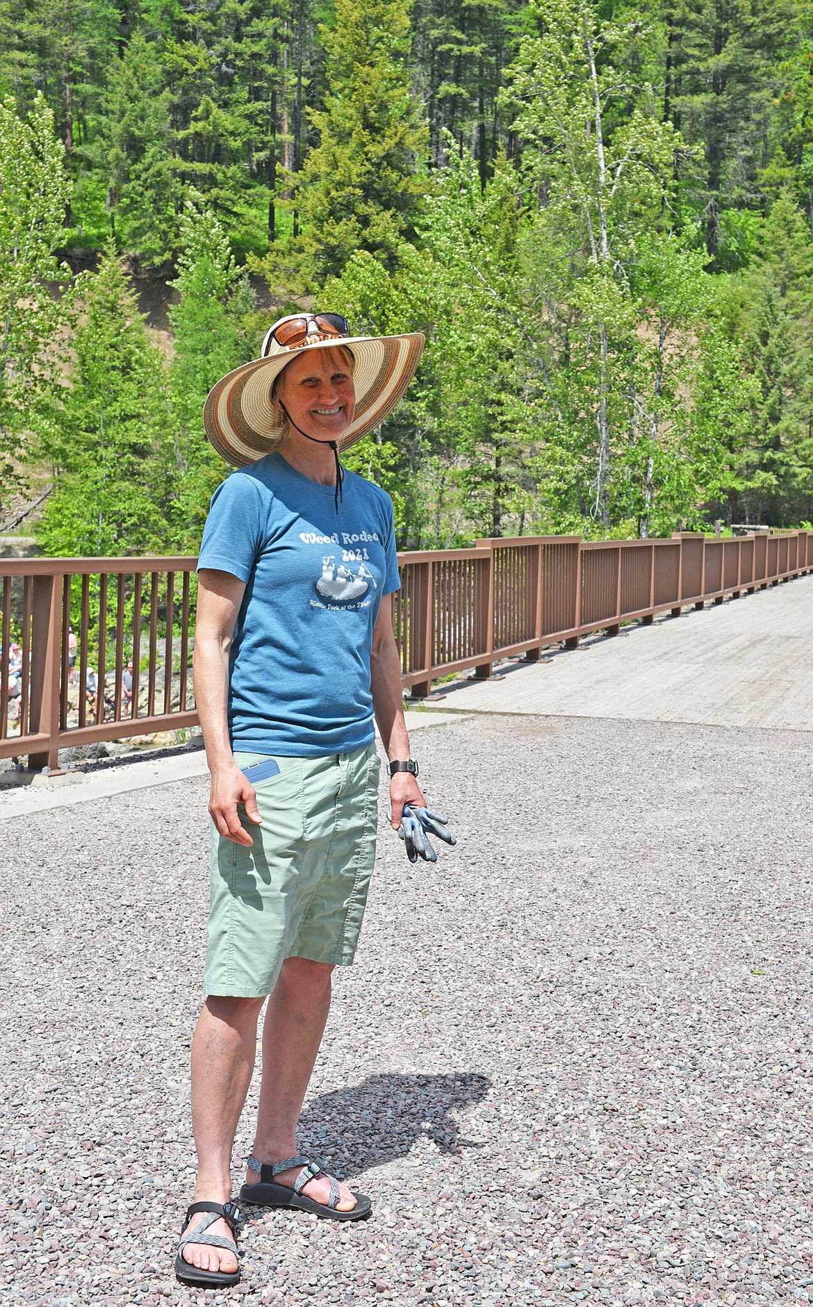 Brenda Guzman, founder of the Weed Rodeo, greets volunteers and prepares to pull weeds along the Flathead River. (Julie Engler/Whitefish Pilot)