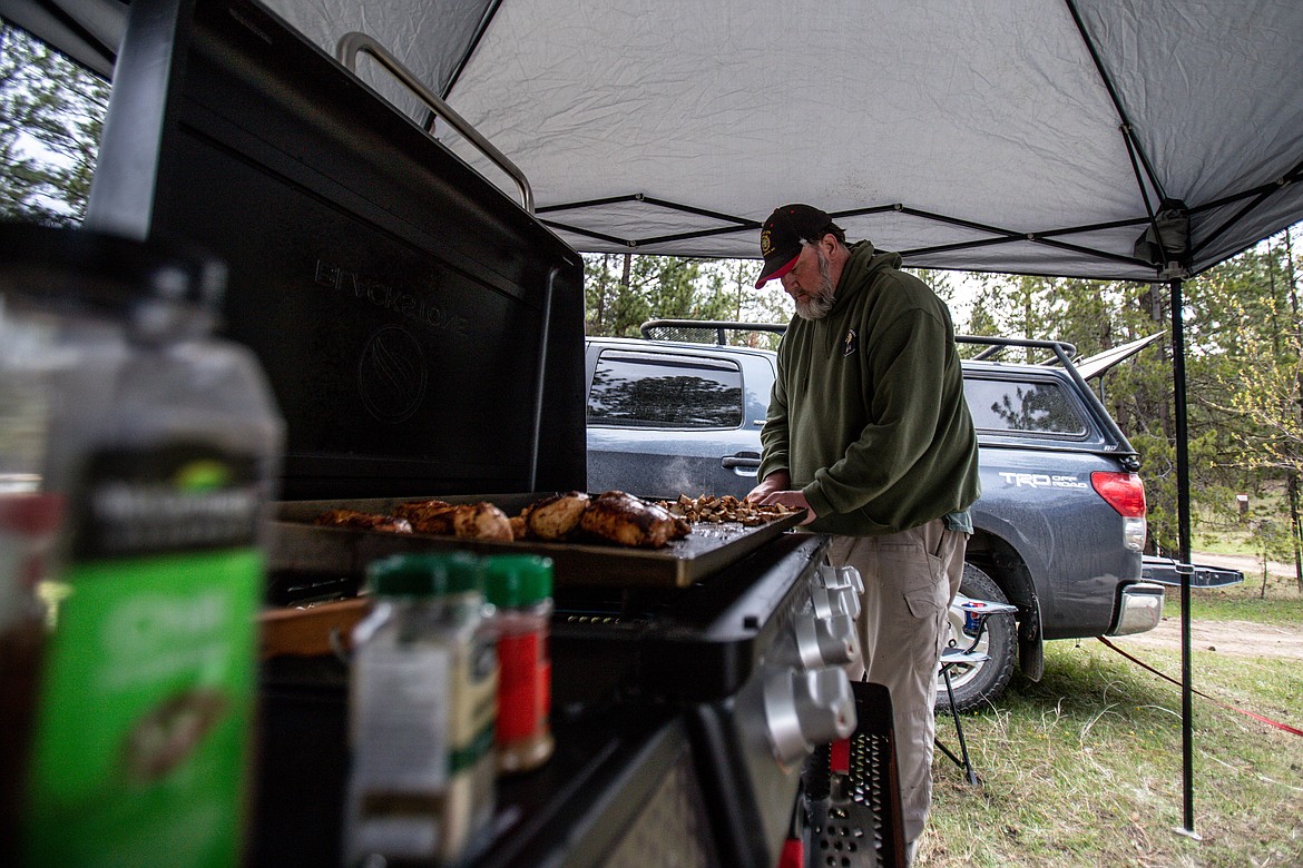 Glen Singleton prepares dinner for a group of Homeward for Heroes campers at Hubbart Reservoir on May 14, 2022. (JP Edge photo)
