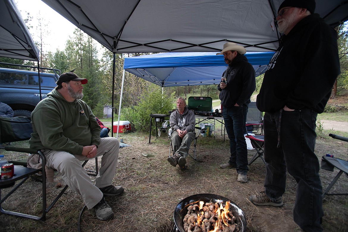 Glen Singleton, Les Aasheim, Bill (Cowboy) Miles and Mason Jacobson talk around the campfire at Hubbart Reservoir on May 14, 2022. (JP Edge photo)