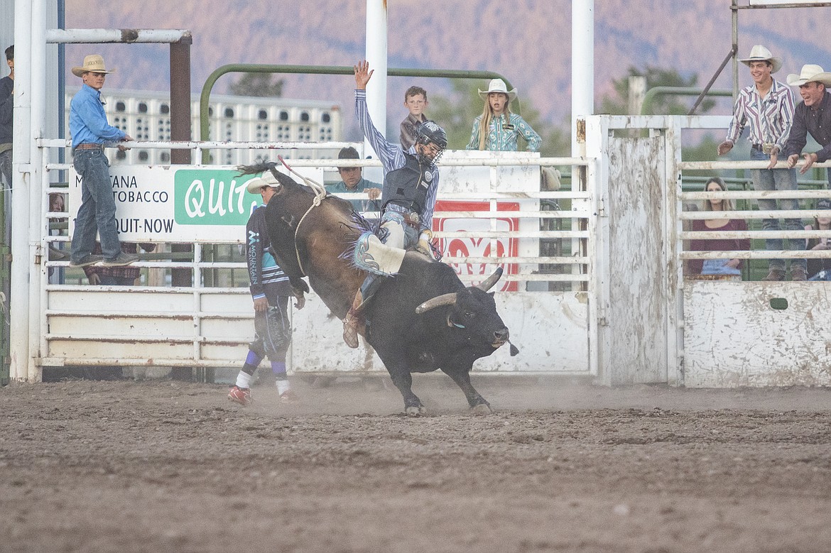 Kyle McDonald, of Ronan, claims third place with a 78-point ride during the Mission Mountain Rodeo. (Rob Zolman/Lake County Leader)