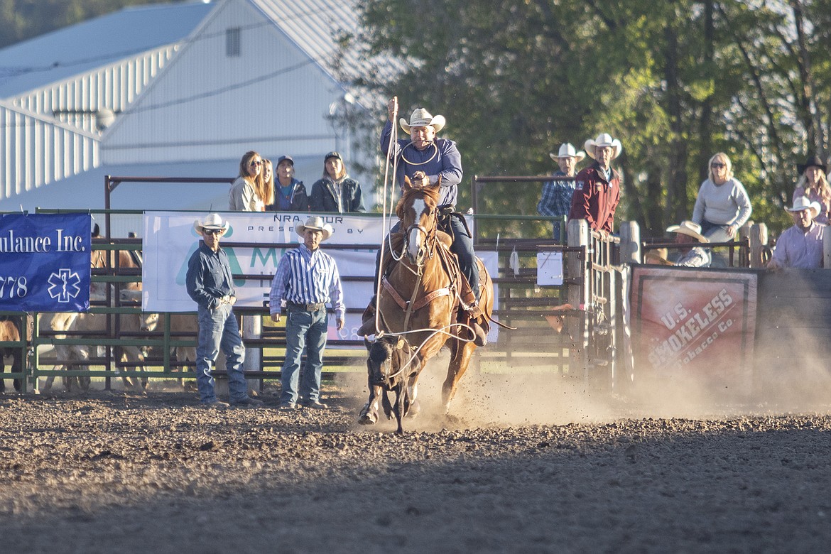 Polson tie-down roper Tim Bagnell wraps up his steer and a second place finish with a time of 11.8 seconds. (Rob Zolman/Lake County Leader)