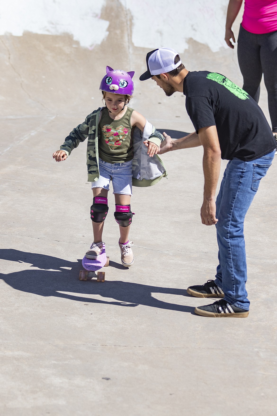 Skate instructor Jesse Vargas offers young skater Meighla Whealon a steady hand. (Rob Zolman/Lake County Leader)