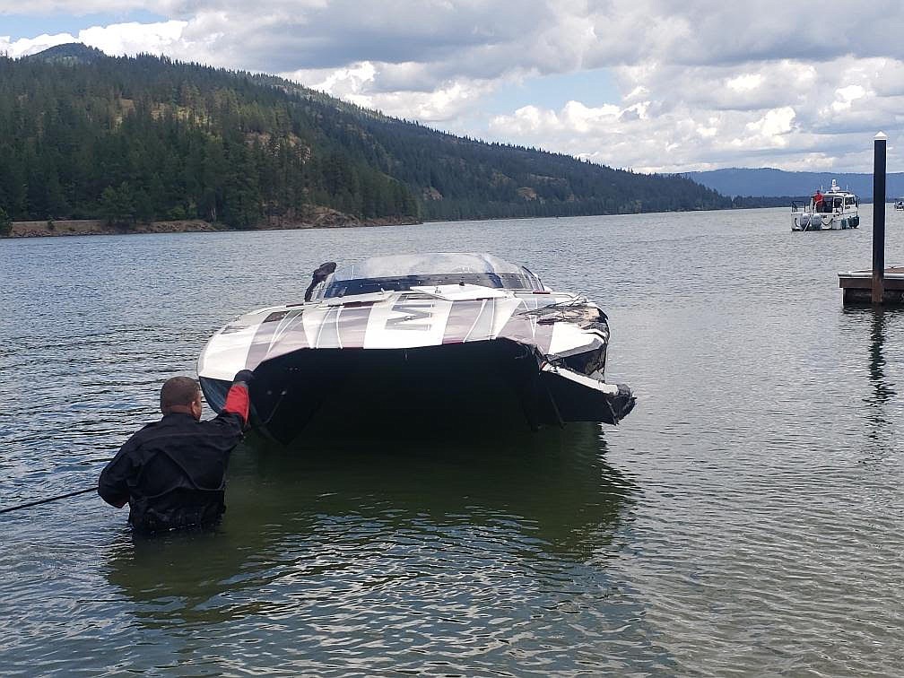 Bonner County Sheriff's Office dive team member helps bring a capsized boat to shore as crews search for missing boaters in the Thama area on the Pend Oreille River.