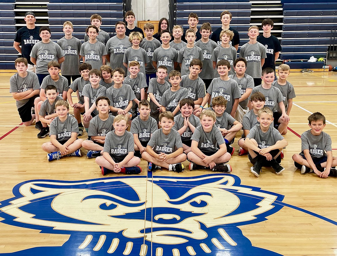 Boys basketball camp participants showing off their camp shirts.