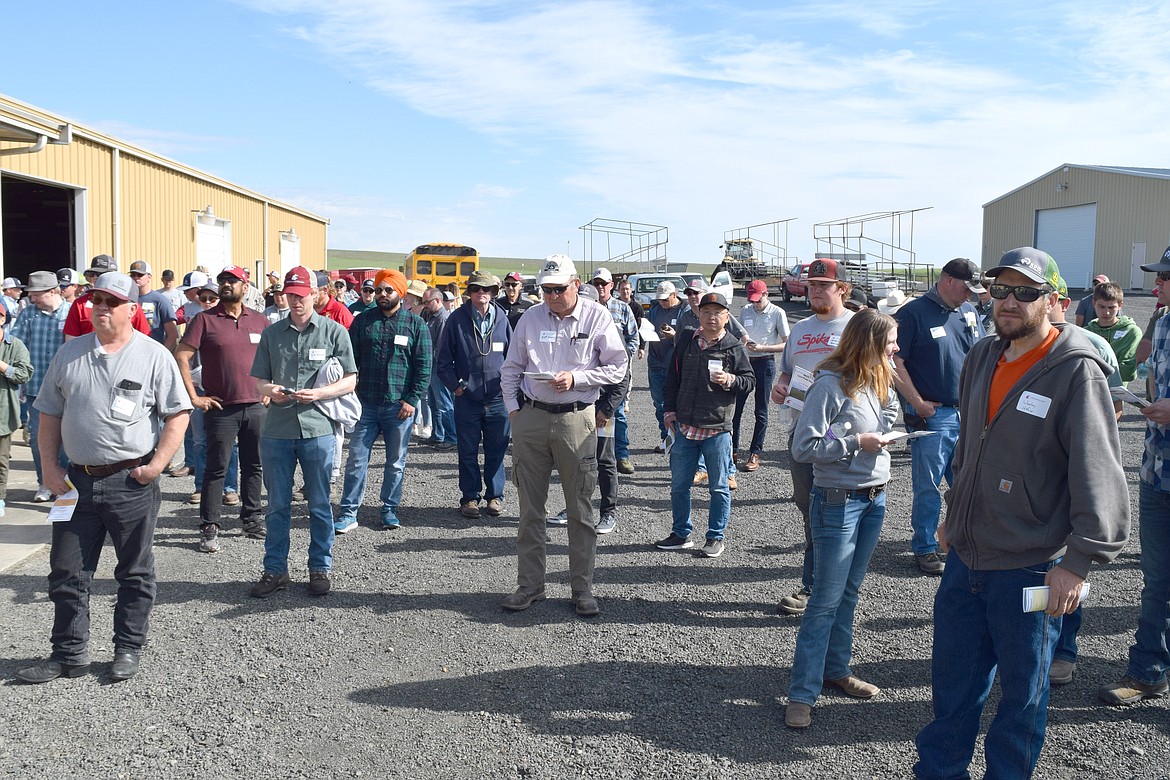 A group of farmers, students and researchers listen to instructions as they prepare to tour the WSU Dryland Research Station in Lind on Thursday, June 16. The research station has held the field day every year since its founding in 1915 except for 1980, following the eruption of Mount St. Helens, and 2020 and 2021 because of the COVID-19 pandemic.