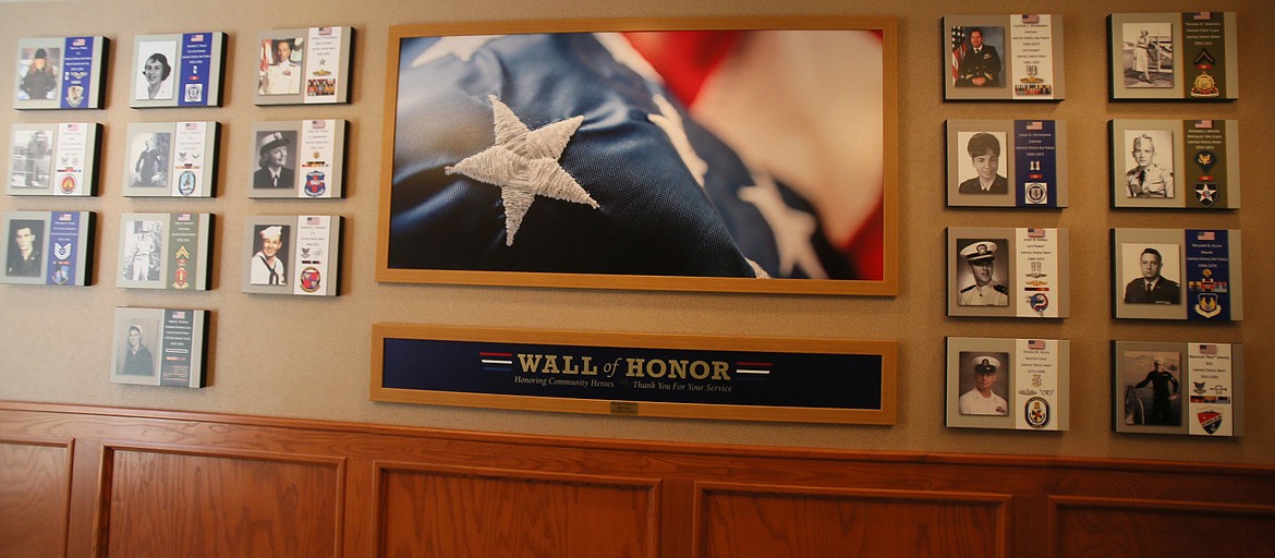 Images of residents and employees who have served in the military are displayed on the Wall of Honor in Garden Plaza of Post Falls.