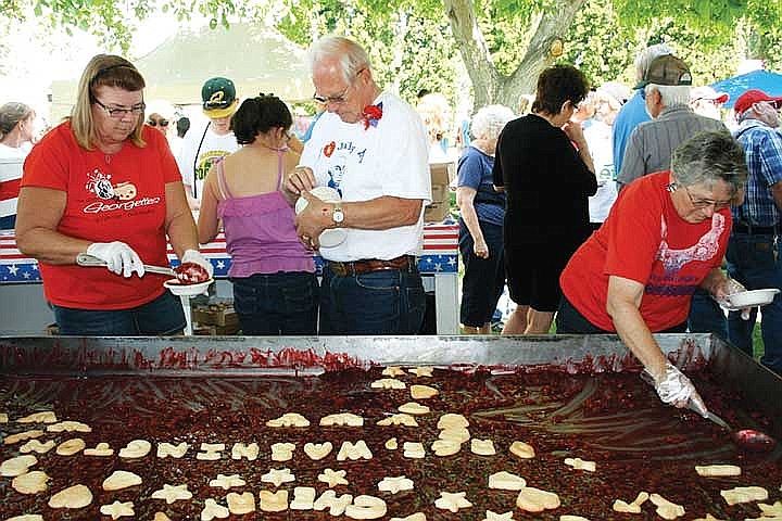 Georgette members and helpers dish up cherry pie at the 2012 July 4 celebration in George during a previous year’s festivities.