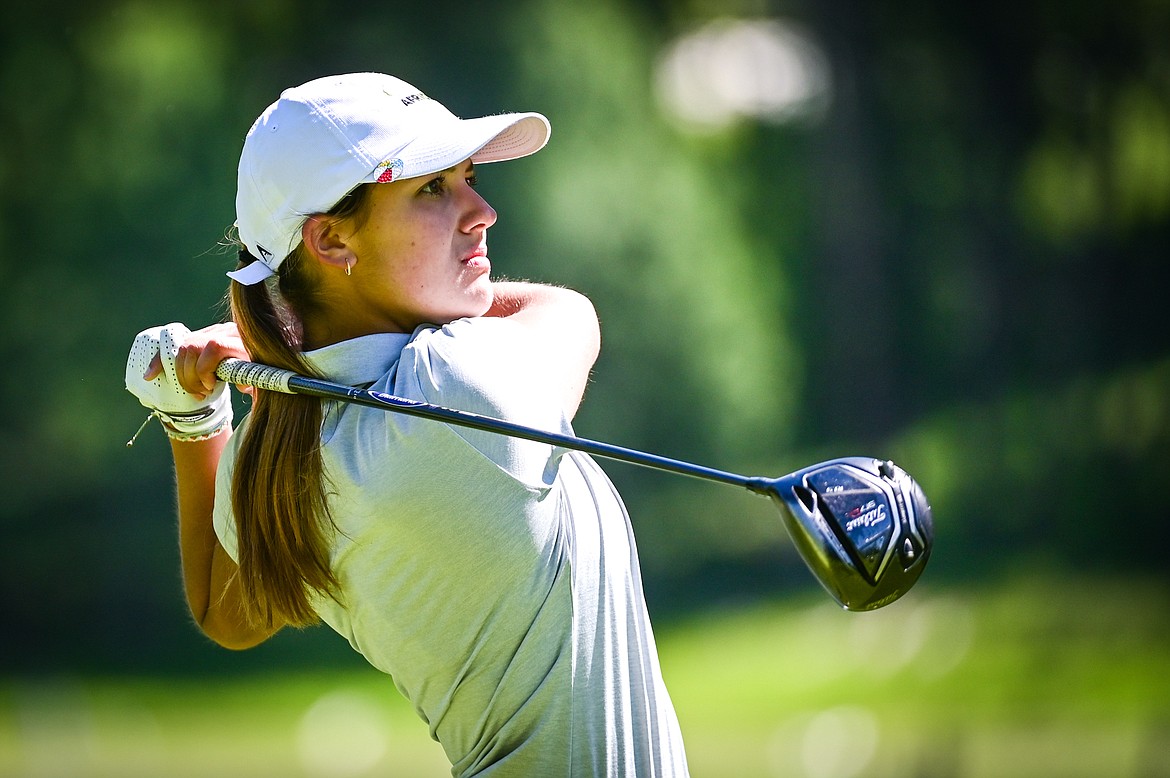 Cora Rosanova watches her tee shot on the eleventh hole of the South Course during the Earl Hunt Memorial Fourth of July Tournament at Whitefish Lake Golf Club on Thursday, June 30. (Casey Kreider/Daily Inter Lake)