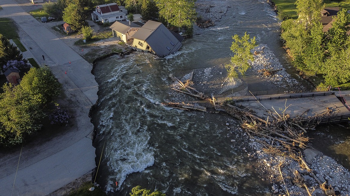 A house sits in Rock Creek after floodwaters washed away a road and a bridge in Red Lodge, Mont., on June 15, 2022.