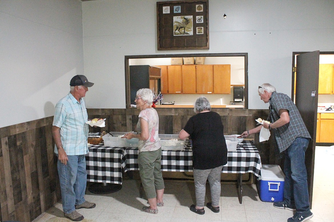 From left: Ray Wardenaar, Maggie Nielsen, Maria Valcarlos and Greg Link help themselves at the Royal Slope Seniors salad luncheon June 23. The group has dwindled in recent years but is trying to rebuild.