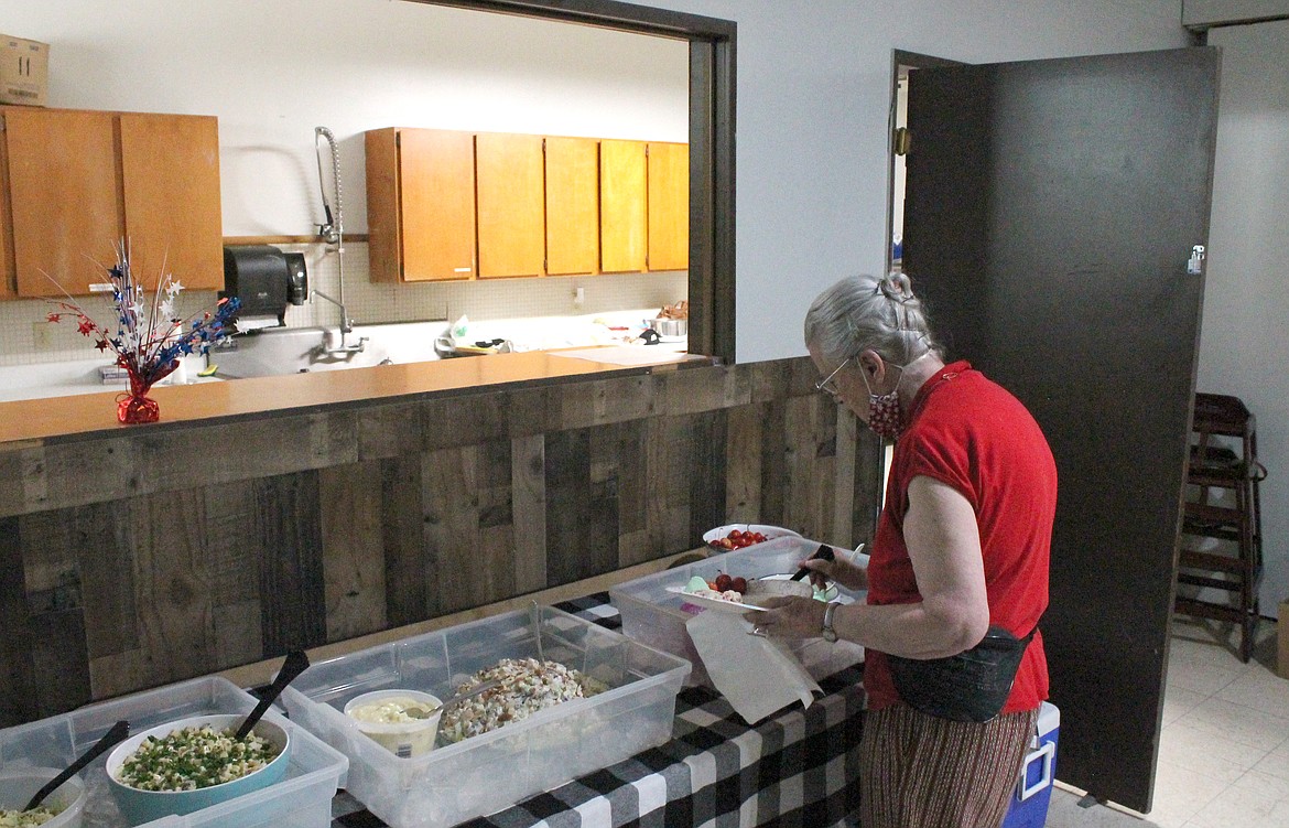 Barbara Gilchrist of Desert Aire checks out the offerings at the Royal Slope Seniors salad luncheon. Barbara and her husband David Gilchrist heard about the group through people they attend church with and came to see what was happening in Royal City.